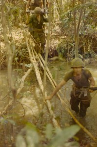 Stream crossing: Squad Leader Lloyd 'Butch' Edge followed by machine gunner Steve York. Song Be, Vietnam 1970