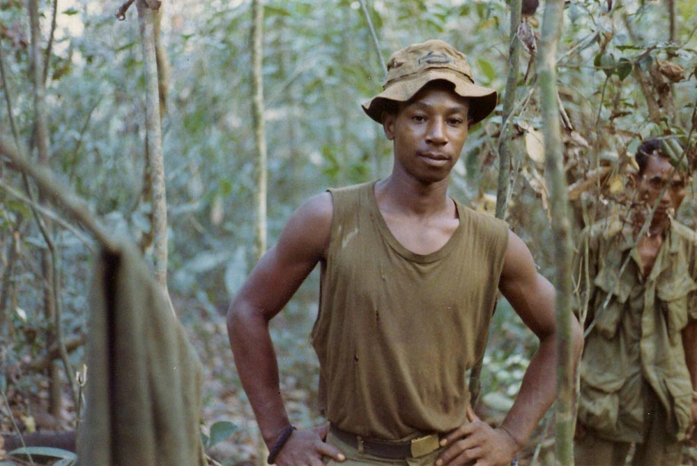 Larry Hunter in the bush. Papa San to his right. Song Be, Vietnam, 1969