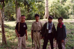Three irregular Cambodian troops with Cambodian army soldier.  Angkor Wat, Cambodia, 1995.