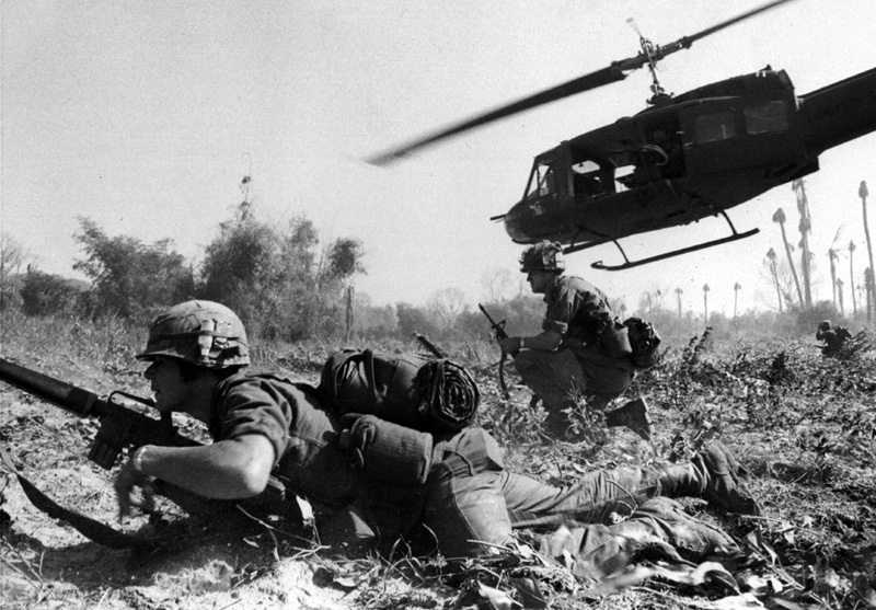 Combat operations at Ia Drang Valley,Vietnam,November 1965. Bruce P. Crandall's UH-1 Huey dispatches infantry while under fire. Photo US Army