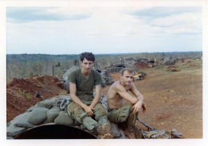 Medic and Jim Lamb sitting on their culvert hooch on LZ Compton. An Loc 1969
