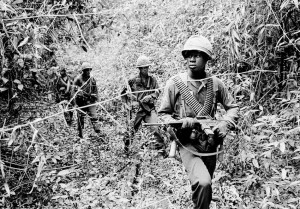  U.S. soldiers are on the search for Viet Cong hideouts in a swampy jungle creek bed, June 6, 1965, at Chutes de Trian, some 40 miles northeast of Saigon, South Vietnam. (AP Photo/Horst Faas)