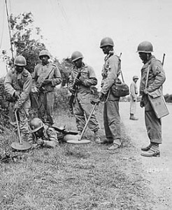 Army Engineers sweeping for mines with SCR-625 Mine Detector, France, 13 July 1944.